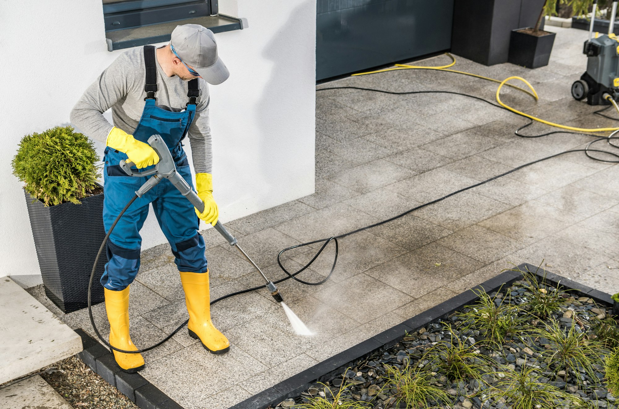 Men Pressure Washing House