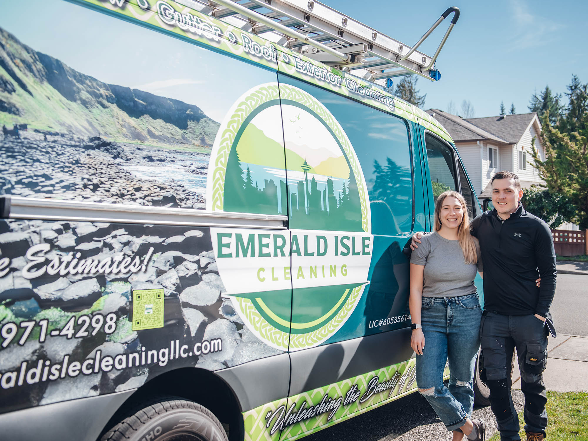 two owners of emerald isle cleaning llc stand in front of their work van facing the camera