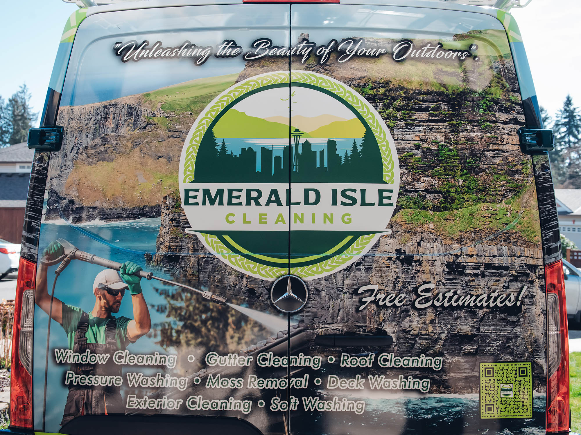 the back of emerald isle cleaning van highlights services including window cleaning, gutter cleaning, roof cleaning, pressure washing, moss removal, deck washing, exterior cleaning, and soft washing